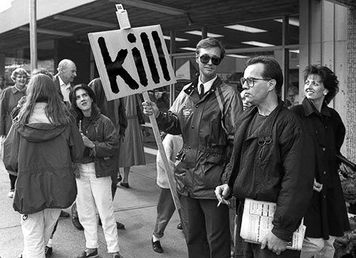 Black and white photo of Gibson interacting with pedestrians and shoppers on Granville Street
