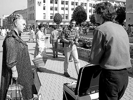 PICTURE: black and white photo of Ms. Piddington talking to Gibson while Plymouth shoppers look on.